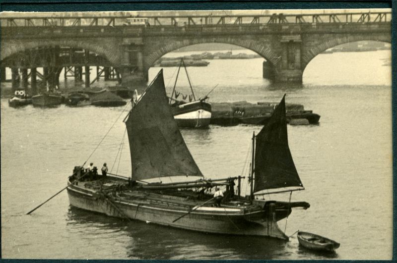  Thames barge. Normally when passing a bridge, the mainmast & gear is lowered, the bridge 'shot', and the gear re-raised, but when working through several bridges a jury mainmast is stepped with a lugsail. 
Cat1 Places-->Thames Cat2 Barges-->Pictures