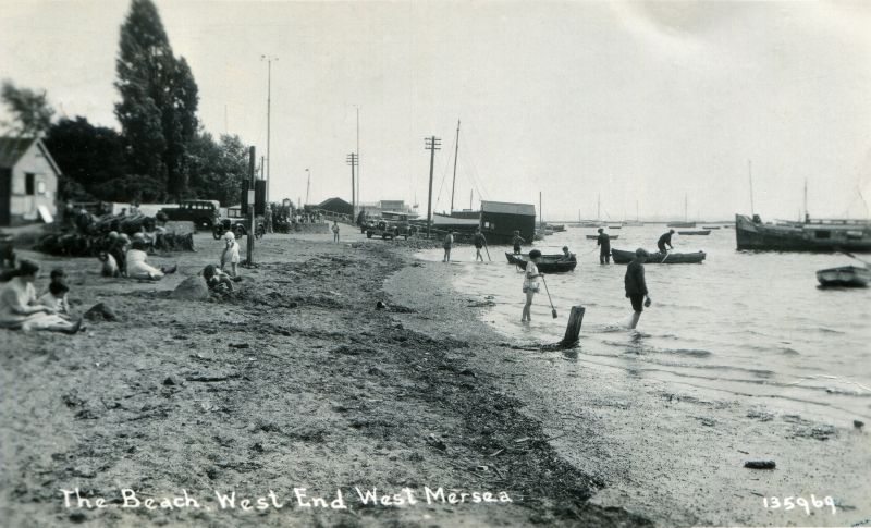  The Beach, West End, West Mersea. Postcard 135969. Taken at the Hard looking back up Coast Road with The Green on the left. The Legend tied up by Clarke & Carter's slipway.

Card posted 10 August 1935 - see  ...
Cat1 Mersea-->Old City & the Hard Cat2 Mersea-->Coast Road
