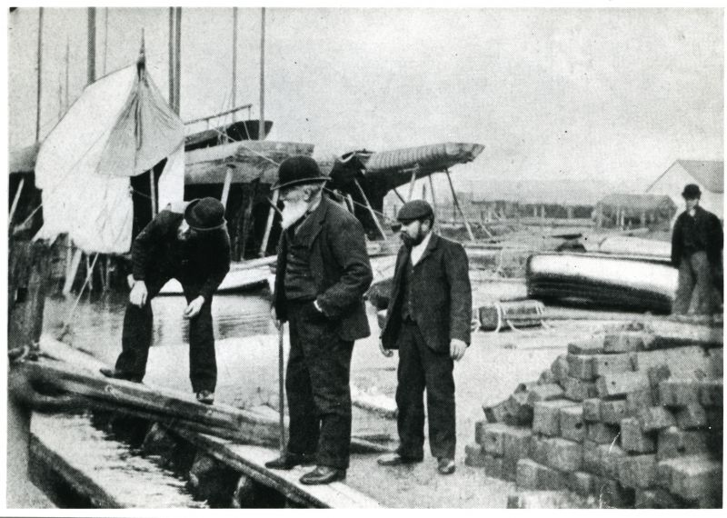  Robert Aldous, Brightlingsea ship, yacht, smack and boat builder (with white beard) inspecting work in his yard with his foreman and later partner Robert Rashbrook in bowler hat

Used in Smacks and Bawleys, Page 129.

Used in The Northseamen page 303 
Cat1 [Not Set] Cat2 Places-->Brightlingsea