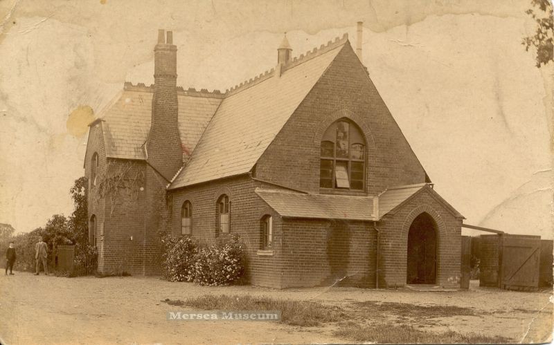  School House and Hall 1910.

The village school was recorded as having places for 80 children with the average number of pupils being 37. The Schoolmaster or Schoolmistress lived in the house which is on the west end of the building. In 1939 the school was closed and all 9 children transferred to West Mersea Primary School.

From display at East Mersea Fete 2003. 
Cat1 Museum-->DisplayPhotos Cat2 Mersea-->East Cat3 Mersea-->Schools-->Pictures