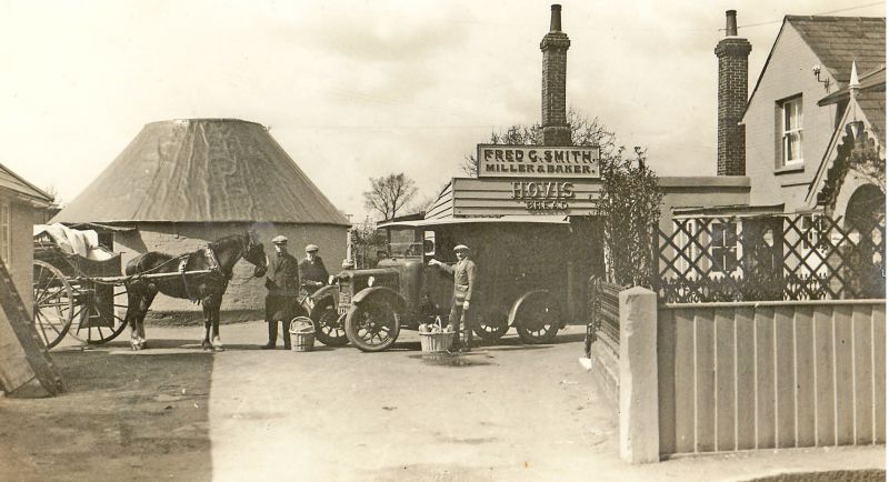 West Mersea Mill - Fred G. Smith. A wonderful photograph of the old and the new. Stanley Mole on the left holding the horse and Herbert Marrow far right with his hand resting on the van door. The Roundhouse remains after the windmill was removed. [AS] 
Cat1 Mersea-->Shops & Businesses Cat2 Transport - buses and carriers