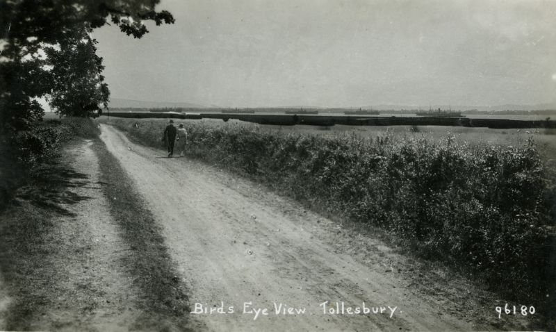  Birds Eye View, Tollesbury. Mell Lane? Postcard 96180 written 12 July 1937.

Laid up ships in the River Blackater - the ship on the right is thought to be DUNVEGAN CASTLE which arrived in the River November 1922 and was departed September 1923. 
Cat1 Tollesbury-->Road Scenes Cat2 Blackwater-->Laid up ships