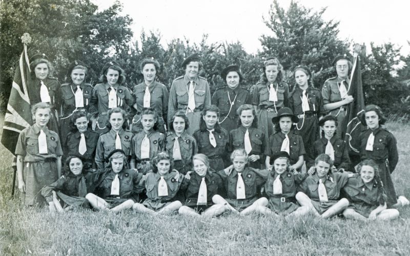  Girl Guides. Another copy of this gives the date and following names:

L-R Back Enid Heard, Ann Gentry (daughter of Gus Gentry), Pam Lee, Elizabeth Page, Mrs Neill (Captain), Barbara Shiel, Brenda Whiting, Adita Hible, Mary Barron.

Middle: Marion Weller, Marina Watsham, Margaret Underwood, Janet Weller, Joyce Mole, Sheila Lane, Ann Green, Shirley Gant, Janet Woodward, Roma Fulcher ...
Cat1 Girl Guides