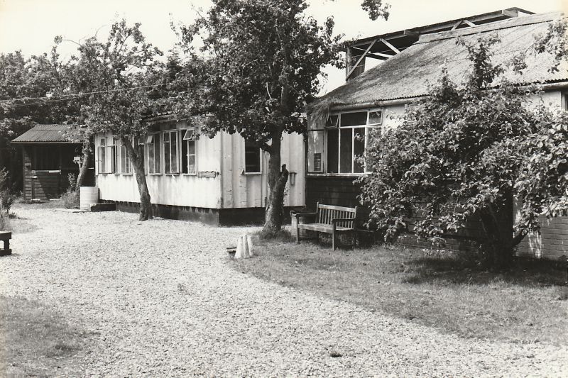  Patricia Catchpole's stables on East Road.

Anne Watson says The second building was put up in 58, we called it Buckingham Palace it was an old prefab that Charlie Buckingham got for her, the trees in the photo were an old apple orchard which she had grubbed out as a turnout paddock, it never grew much grass. We had fields at the top of Norfolk and Suffolk avenues as well as Cross Lane and ...
Cat1 Mersea-->Buildings Cat2 Mersea-->Shops & Businesses