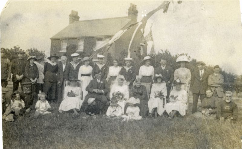  Wedding of Samuel James Mills and Nellie French. The happy couple, surrounded by family and friends, are posing for a group photograph at the top of Victory Road. The house at the back of the picture is in St. Peters Road. 

Back row 1. Tom Clarry, 2. Percy Chatters, 3. ?, 4. Mrs Wass, 5. Mrs Clarry, 6. Mrs Chatters, 7. Burton Hewes, 8.& 9. Mr & Mrs Fred Mills, 10. & 11. Mr & Mrs Eddie ...
Cat1 Families-->French Cat2 Families-->Hewes Cat3 Families-->Mussett