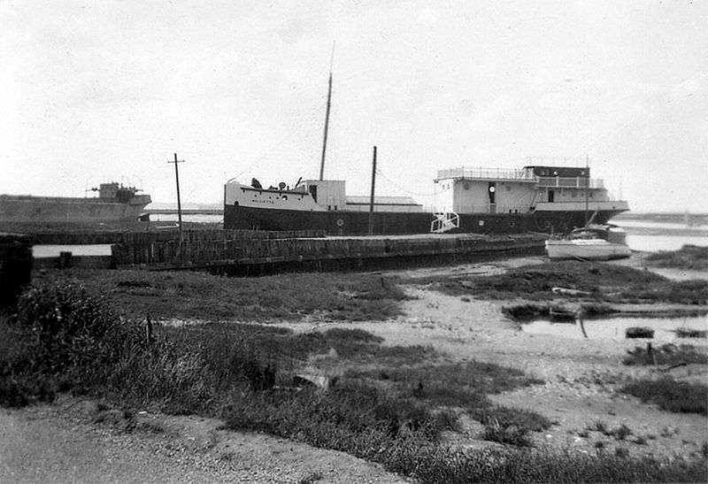  There are two concrete boats in this picture. On the left is CRETACRE, built Hamworthy in 1918 and owned in Mersea 1933-38. In the centre is MOLLIETTE - a well known local houseboat, built of concrete in Faversham in 1919. She lay in front of the VICTORY for many years, used as West Mersea Yacht Club clubhouse. Her remains lie off East Mersea, sunk as a target in World War 2. 
Cat1 Ships and Boats-->Merchant -->Sailing Cat2 Mersea-->Coast Road