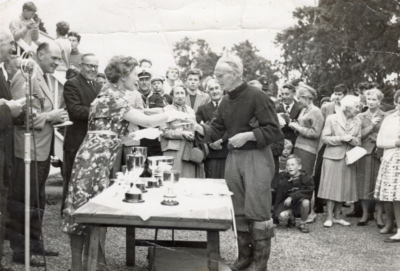  Fid Harnack collecting his prize from Aline Gowen in the 1950 West Mersea Town Regatta.

Ted Winfield amd Harry Stevens to left of Aline. John Shelton to right of Fid.

Used in Fid Harnack RSMA, published by Mersea Island Museum Trust. 
Cat1 People-->Other Cat2 Mersea-->Regatta-->Pictures