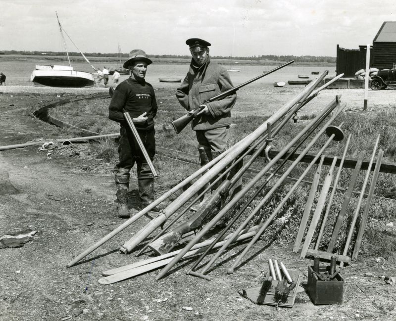  The well known author & wildfowler J. Wentworth Day with a local West Mersea wildfowler and all their weapons and tools. Similar one published. [DW]

A wildfowlers' armoury: Tollesbury fisherman and wildfowler Will Leavett (left) discusses an outfit with nature writer James Wentworth Day on West Mersea hard. Items include the mast and sprit for a punt's rig; a long-barrelled punt gun and its ...
Cat1 Mersea Cat2 People-->Other Cat3 Wildfowling