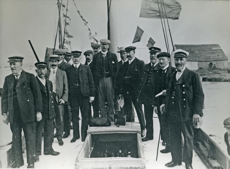  Regatta committee aboard committee smack at Wivenhoe regatta about 1910. Refreshments for members visible down main hatch.

Used in The Northseamen page 79. 
Cat1 Places-->Wivenhoe-->Town Cat2 People-->Other