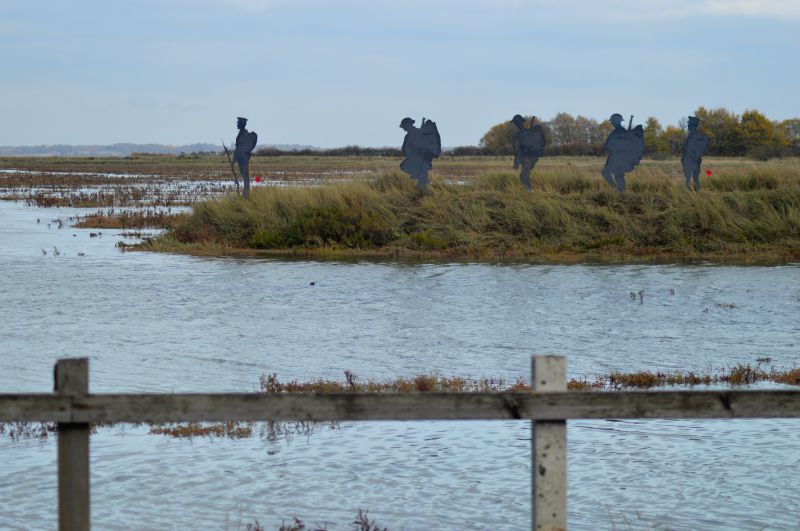  East Mersea men atop the old sea wall looking to the mainland.

WW1 Memorial at the Strood. 51 Mersea Island soldiers and sailors. 
Cat1 Mersea-->Strood Cat2 War-->World War 1
