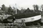 54. ID FL01_078_002 Jack Botham surveying damage to his houseboat WAVENEY after the 1953 flood.
From Album 1.
Cat1 People-->Other Cat2 Disasters and Mishaps Cat3 Disasters and Mishaps