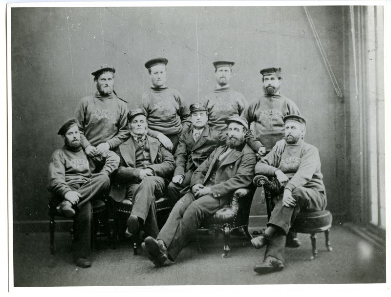  Crew of racing cutter NEVA. Captain Lemon Cranfield of Rowhedge, seated in chair second from right, front row. One of the smartest racing crews in history with a phenomenal prize record.

Used in The Northseamen, page 130. 
Cat1 People-->Fishermen and Seamen Cat2 Places-->Rowhedge