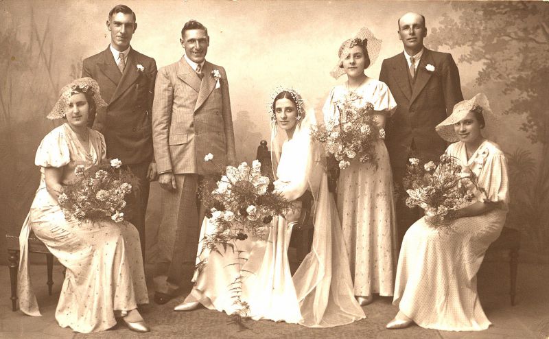  This is a studio portrait taken after the marriage of Benjamin James George Clarke and Constance Nellie Mole at the church of St. Peter and St. Paul on 18 July 1936. Ben's brother, Albert, stands on his right. Ben was a shipwright who had a boatyard in The Lane for many years. His nephew Peter continued his business and now runs Peter Clarke's Boatyard. 
Cat1 Museum-->DisplayPhotos Cat2 People-->Other