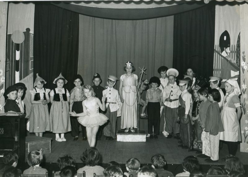  Birch School. Wedding of the Painted Doll produced in the Village Hall, c1955.

Anne Baines on pedestal in the centre. Michael Lynch golliwog to the right of her.

Essex County Standard photo 4571/B. 
Cat1 Birch-->School
