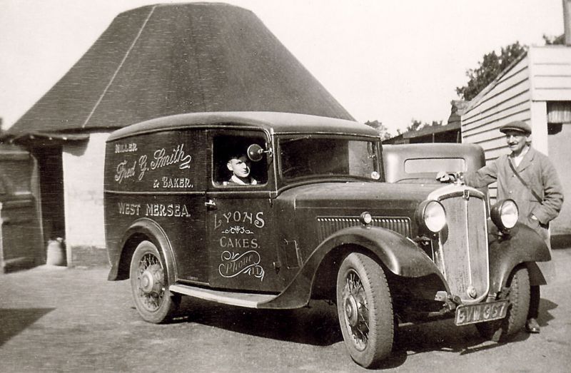  Frederick Herbert Smith and Herbert Marrow with Fred G. Smith delivery van. It is a Morris, registration BVW367. The door advertises Lyons Cakes. Phone Number 11. 
Cat1 Mersea-->Shops & Businesses Cat2 Transport - buses and carriers Cat3 Families-->Smith