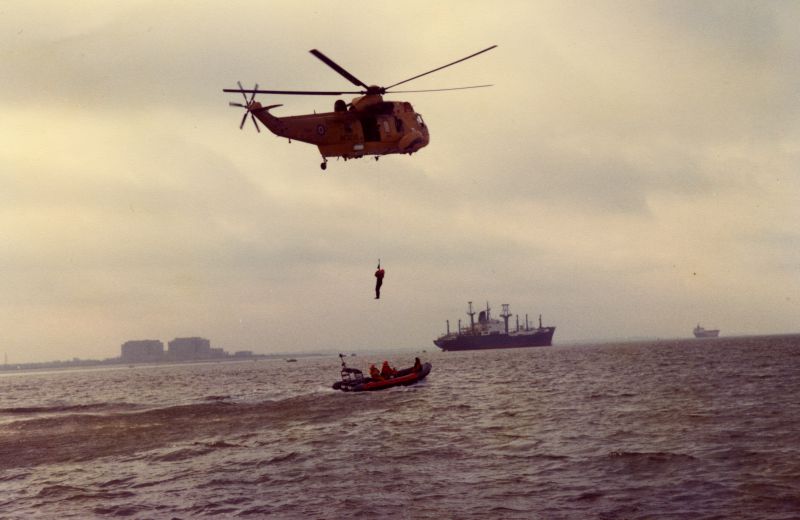  West Mersea Lifeboat exercise with RAF Sea King helicopter. Laid up ships FLAMAR PRIDE or FLAMAR PROGRESS, with a Manchester Liner in the distance. 
Cat1 Mersea-->Lifeboat-->Pictures Cat2 Blackwater-->Laid up ships
