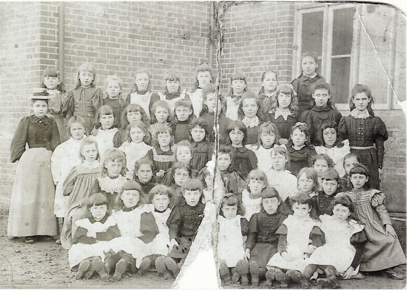  Tollesbury School, circa 1891. Annie Rice (teacher) far left. 
Cat1 Tollesbury-->People Cat2 People-->School