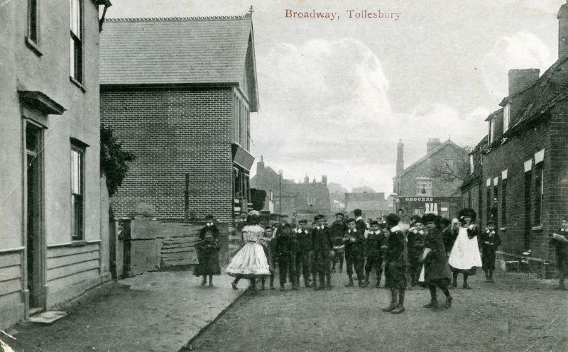  Broadway, Tollesbury. The view from East Street looking west to The Square. Holman's shop in the distance. Postcard.

Used in More from Tollesbury Past Plate 30. 
Cat1 Tollesbury-->Road Scenes