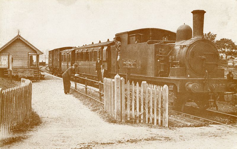 7053 at the Station. Postcard, not mailed.

Pictured in the 1930s is a mixed train arrival from Kelvedon. LNER information boards but original GER 'Trespassers' notice remains. Saturday rates for parties are advertised. Note: station buckets, the platelayer's hut (background), cattle loading pens (right). J69/1 0-6-0 Tank engine ( later BR 68619 ) finally became the spotlessly maintained east ...
Cat1 Tollesbury-->Transport