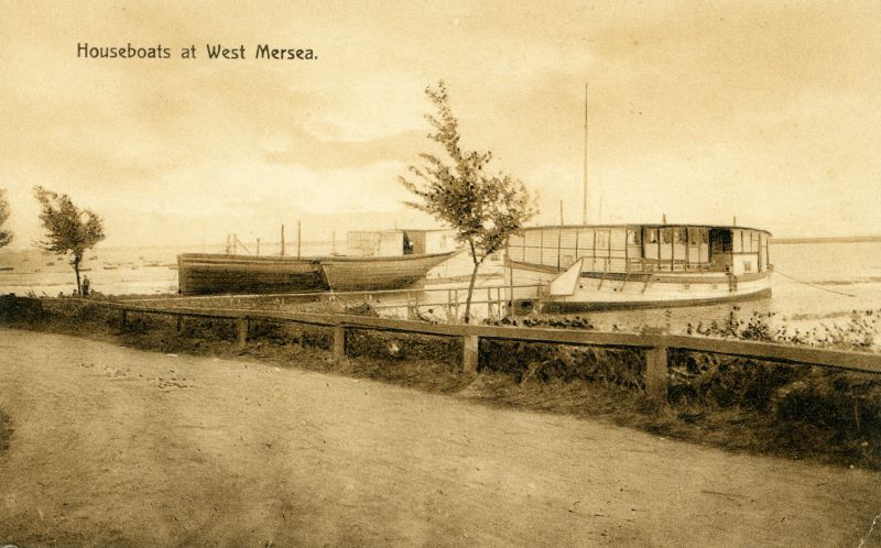  Houseboats. ERYCINA (left) and EVANDRA (Fifie) formerly WMYC headquarters. In 1910 EVANDRA is mentioned in Yachting World [BOX115_001] as providing accommodation for nine members. The EVANDRA had been bought by Mersea Yacht Club (as West Mersea Yacht Club was initially known) from their Captain, Frederick Leith. She was sold in 1916.

Another copy of this card was posted 18 September 1913. 
Cat1 Mersea-->Houseboats Cat2 Mersea-->Coast Road