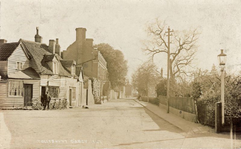  Tolleshunt D'Arcy. The cycle shop is Kingfisher Cycles. Postcard 147. 
Cat1 Places-->Tolleshunt D'Arcy