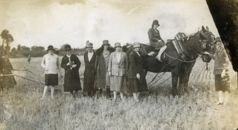  Ploughing Match

From left 1. Mrs Harry Hoy, 2. Mrs Bob Salmon, 3. Mrs Alice Johnson (holding a prize-winner's cup), 4., 5. Mrs Clarence Cudmore, 6. Mrs Henry Farthing, 7. Hrs Jenny Hoy, 8. Mrs Cooty Hoy (on horse), 9. Mrs Goldie Green.

From Album 6. 
Cat1 Mersea-->Events Cat2 Families-->Green Cat3 Families-->Farthing