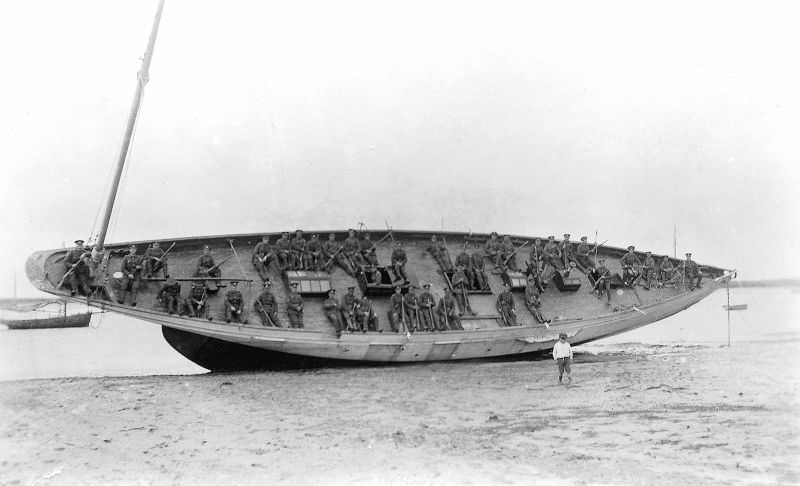  Members of the regular company take it easy on the deck of the yacht L'ESPERANCE which is lying on the Hard awaiting removal of her lead keel before being put into a mud berth to be used as a houseboat. 

One of the Officers on the deck was a member of the Ingleby family, who owned L'ESPERANCE built in the years before WW1 - he was probably responsible for getting this photograph ...
Cat1 Mersea-->Houseboats Cat2 Yachts and yachting-->Sail-->Larger Cat3 War-->World War 1