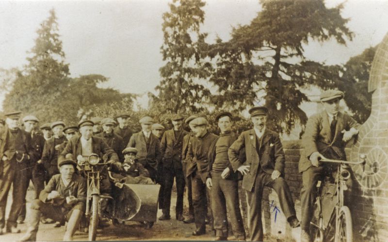  Uncle Whitey Mussett, (Aunt Maud's husband). By the barometer at the Square, Coast Road.

On the right is Kenny Bacon - on bicycle with acetylene light. 
Cat1 People-->Other Cat2 Mersea-->Coast Road