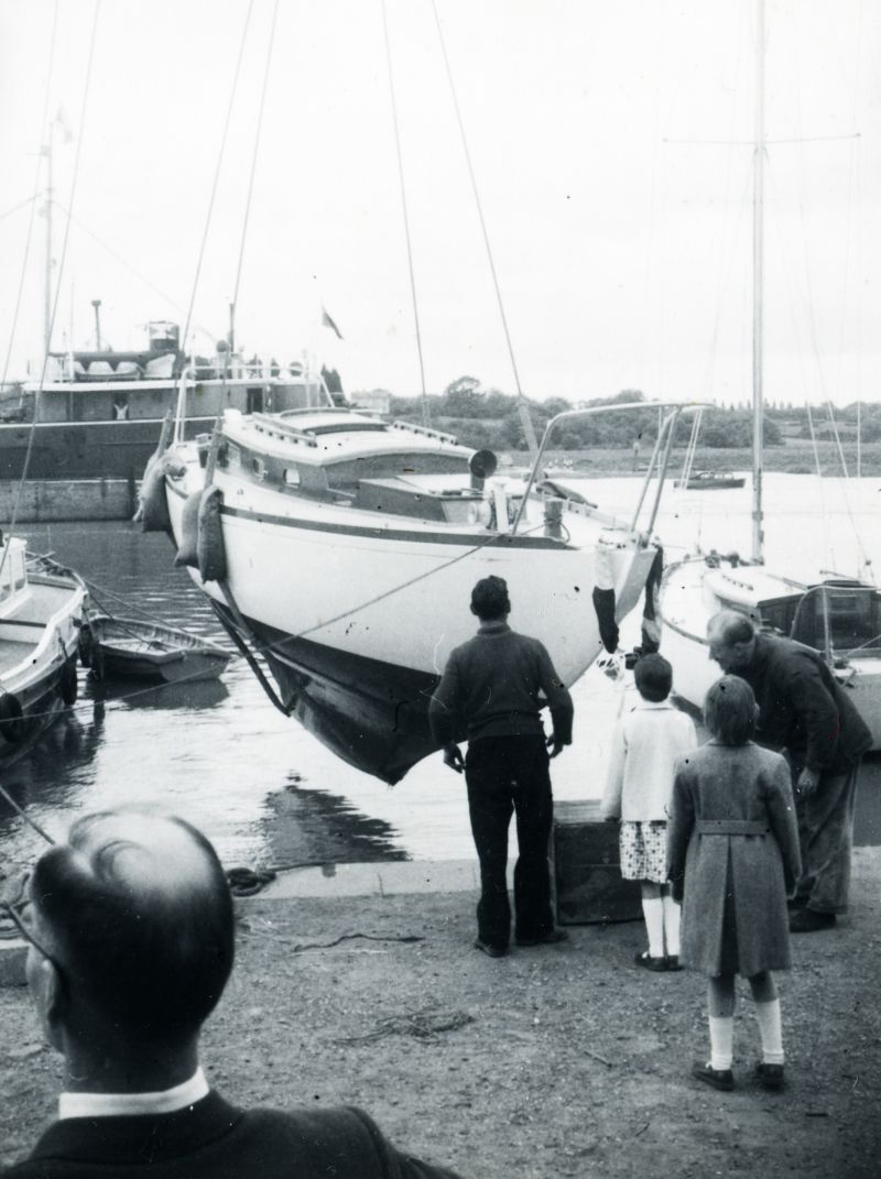  Launch of yacht JANMER, built for Norman Ward at Colne Marine [Guy Harding], Wivenhoe. Ann Ward, with Wigs (Francis) nearer the camera. Everard coaster passing in the Colne. 
Cat1 Yachts and yachting-->Sail-->Larger Cat2 Places-->Wivenhoe-->Shipyards