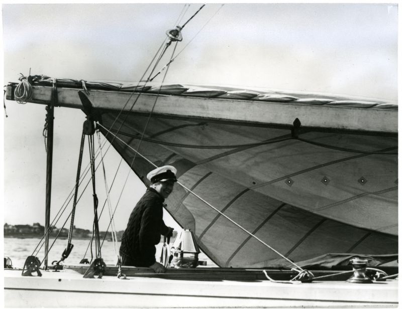  Mrs. Vanderbilt in the cockpit of VIM as the 12 metre prepares to race at Harwich, Monday, June 12th 1939. A reef has been taken in the mainsail with a lacing line, in anticipation of the freshening wind. The spruce boom rests in the crutch and the fine Egyptian cotton mainsail is bellying away to leeward before being hoisted. The mainsheet arrangement differed from those in contemporary British ...
Cat1 Yachts and yachting-->Sail-->Larger Cat2 Places-->Harwich