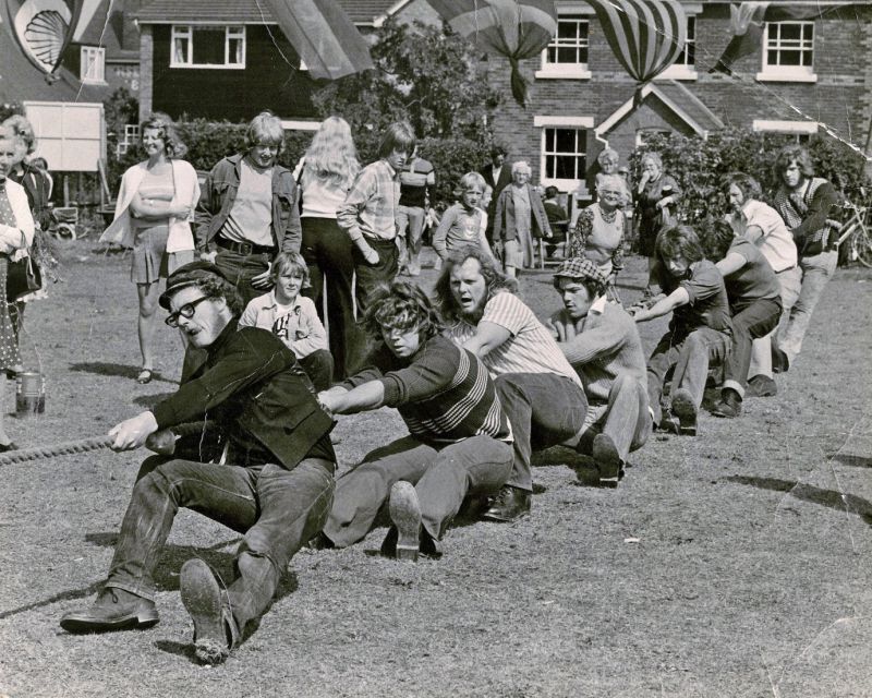  Peldon Tug of War Team at West Mersea Lifeboat Fete, 1973. 
 The venue has since been built on and is now the site of Kenston Court in West Mersea High Street, diagonally opposite Tesco's In this view looking east, the houses at the back are on High Street. 
Cat1 Places-->Peldon-->People Cat2 Mersea-->Events