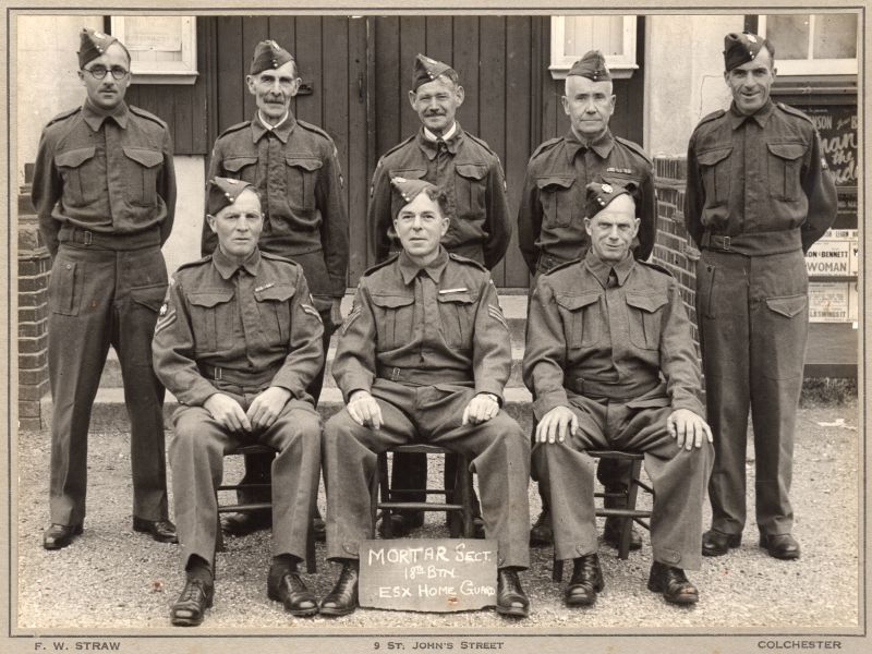  Mortar Section of 18th Battalion Essex Home Guard, West Mersea.

Back row 1. Nathan Si Smith, 2. Jim Groom, 3. Jack Marsh, 4. John French (Bank Manager), 5. Fred Dubbin Cudmore.

Front row 1. Bert Cornelius (lived next door to Millcroft in Upland Road), 2. Oswald E. French (Shoe Shop), 3. Alfred 'Did' Lee.

Photo by F.W. Straw, St Johns Street, Colchester. 
Cat1 War-->World War 2