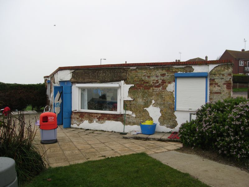  Two Sugars Cafe - a former gun emplacement on Victoria Esplanade, West Mersea. Constructed 1940 by Taylor Woodrow. The rendering was removed, showing the fletton brick construction underneath, with traces of camouflage paint. The large steel doors were removed a long time ago, but their hinges are visible to the right of the large window. 
Cat1 Mersea-->Shops & Businesses Cat2 War-->World War 2