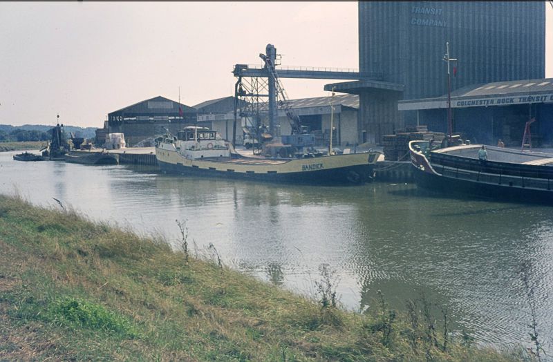  BANDICK loading grain at Colchester Hythe in the 1970s. Beyond her, extreme left, is the COLNE DREDGER. 
Cat1 Ships and Boats-->Merchant -->Power Cat2 Places-->Colchester-->Hythe