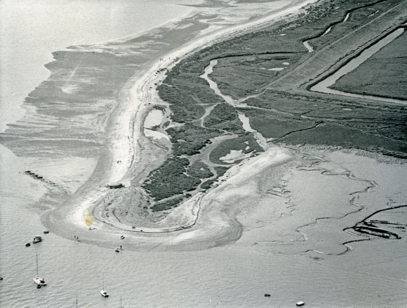  Jack Botham aerial photograph 9102A. East Mersea Stone. The pillbox can be seen on brow of the beach - it is now some distance away.

The remains of the Blockhouse Fort are visible, just above centre, just to the south of the sea wall. 
Cat1 Aerial Views-->Mersea