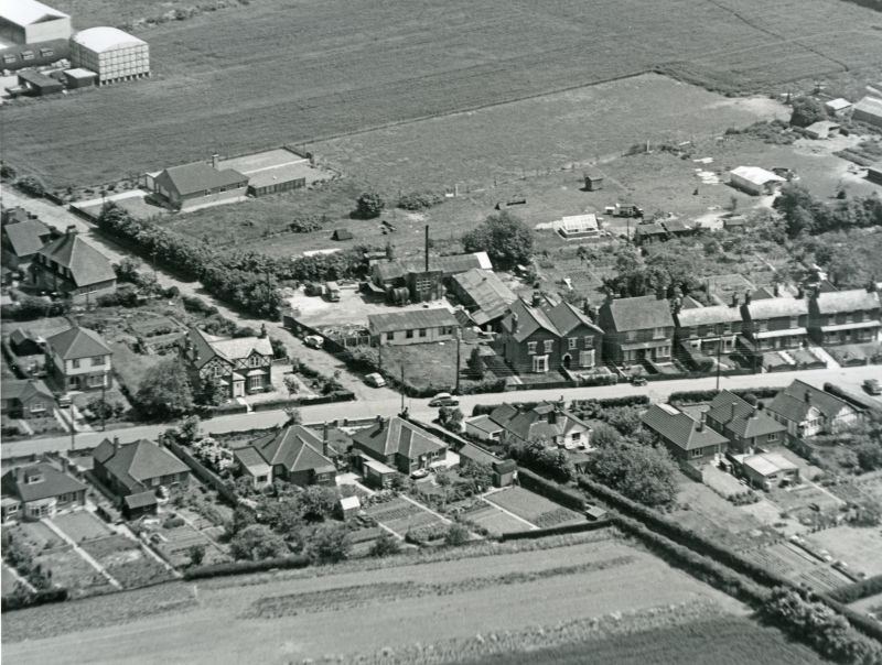 Jack Botham aerial photograph 3309. Junction of High Street North and Upland Road, which is continued as a bridle way to the bottom right hand corner. The Electric Laundry is in the centre. 
Cat1 Aerial Views-->Mersea