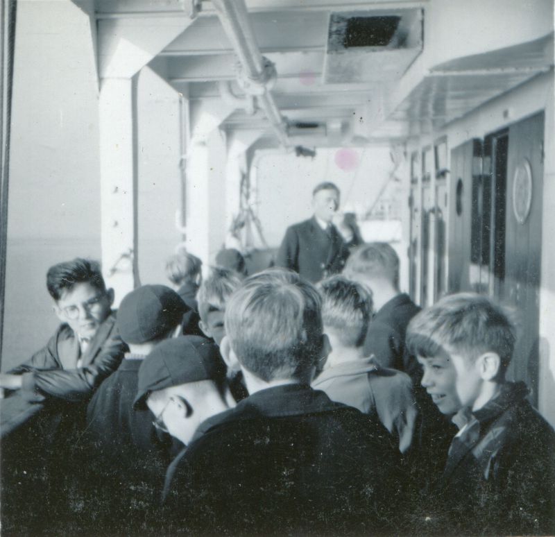 School trip from Heybridge to the liner GOTHIC while she was laid up in the River Blackwater. Walter Bibby, the donor's father, was a master at the school. Date: cJuly 1957.