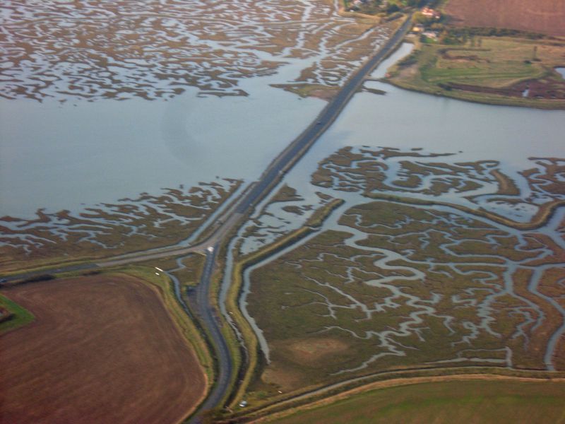  The Strood looking towards Colchester. Lower right is the broken sea wall and area that has gone back to saltings. 
Cat1 Aerial Views-->Mersea Cat2 Mersea-->Strood