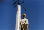 David Mussett painting the weathervane pole on top of West Mersea Church tower. David had previously shinned up the pole to put the weathervane in its hole 1985. Photo: David Mussett Collection
