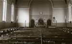  Tollesbury Congregational Church. Interior. Postcard dated 10 August 1915 which says notice the harmonium and oil lamps.  CG11_111