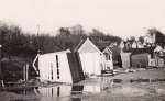  Beach Huts at West Mersea after the 1953 Flood. The western end of the huts, by the corner of Broomhills Road.  IA02_015