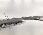  River Colne down to the Sea by Douglas Went. Photograph 34.
 Wivenhoe - sheerleg crane above Upper Yard. From Rowhedge.  DW18_061