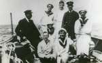  Captain Harry Pettican and crew of SUNSHINE.
 L-R Captain Pettican, Harry Milgate, Syd Mills, Eric [sic] [Ernest] Appleton (Mate), Uriah Lewis.
 L-R seated - Harry Redhouse, Peter Owen, Cliff Rice.
 Caption has more names than the photograph.
 The Book Tollesbury in the year 2000 says Captain Harry Pettican became skipper of the 70ft schooner SUNSHINE in 1908. She was owned by Newcom Carlton, the President of Western Union. With brother in law Harry Redhouse as steward, Captain Pettican brought Tollesbury hands out to the USA to sail SUNSHINE through the summer. These included Ralph Frost, Joe Heard, Dick Holder and Tom Sampson. Mr Carlton sold SUNSHINE during WW1.  CG6_273